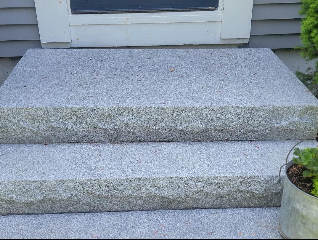 Thermal-top granite slab entry steps with rock-faced edges