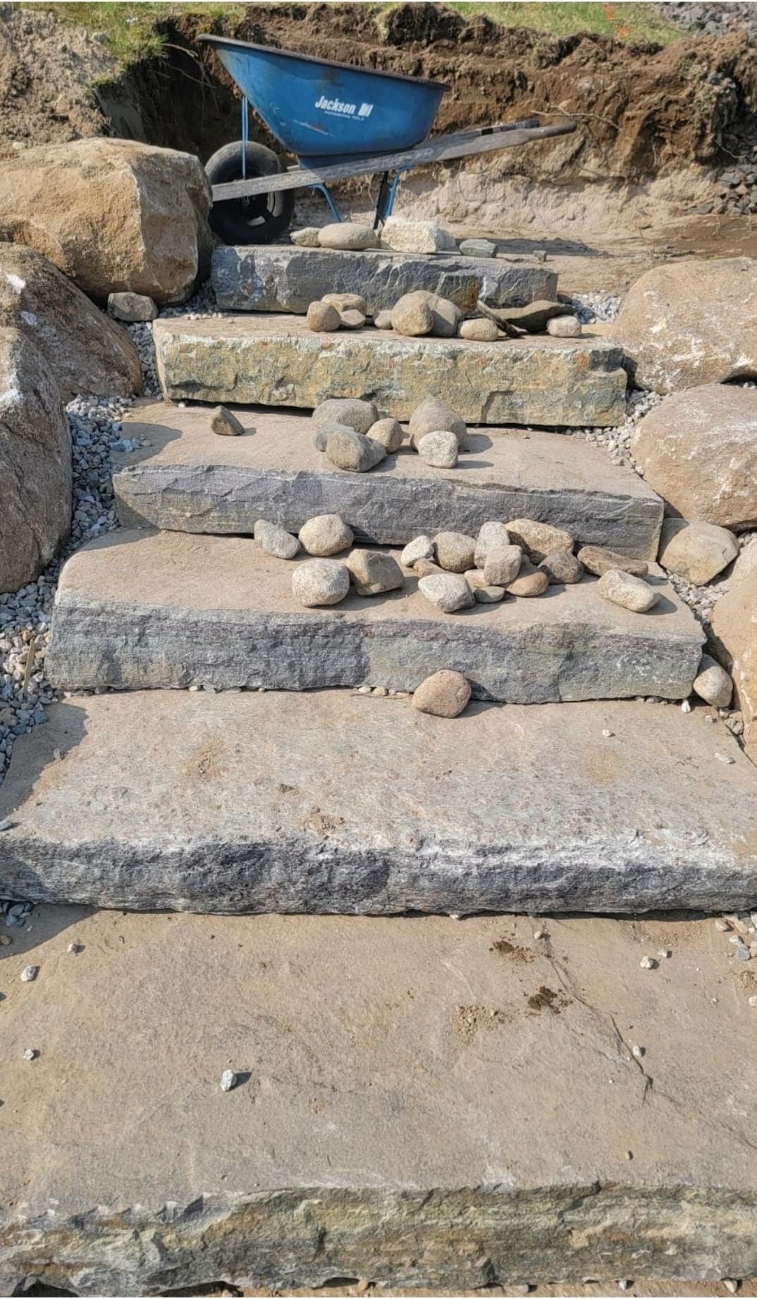 Massive natural stone slab staircase set between boulders